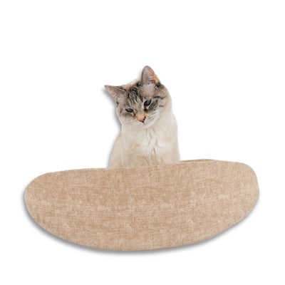 The Cat Canoe modern cat bed is made with neutral tan fabric. The bed is lined with a tone-on-tone geometric square print.  The model weighs 7 pounds, and our banana-shaped cat bed fits cats to about 18 pounds. 