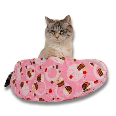 The Cat Canoe® is a boat shaped pet bed, some people think it looks like a taco. Made here in a cute pink cupcake fabric.