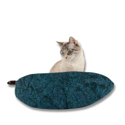 The Cat Canoe modern cat bed is made here with a teal batik with interesting color dimensions. The contrasting lining is cranberry red. These fabrics are 100% cotton.