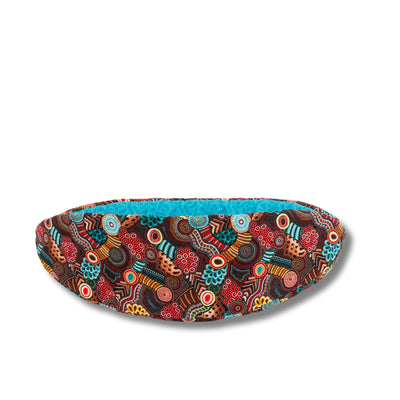 The Cat Canoe modern cat bed is made with a bold print that references Aboriginal Australian design and patterns.  Our innovative taco-shaped cat bed design is long and narrow with high sides and the foam-filled panels allow fat cats to get in. 