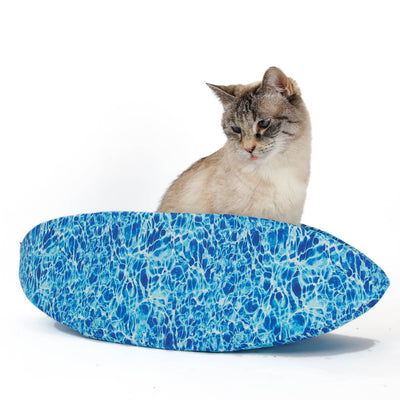 The Cat Canoe modern pet bed designed to look like a swimming pool. We used realistic digitally printed fabrics to make this taco-shaped cat bed, with water on the outside and lined with green grass.