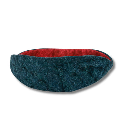The Cat Canoe modern cat bed is made here with a teal batik with interesting color dimensions. The contrasting lining is cranberry red. These fabrics are 100% cotton.