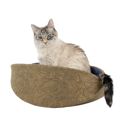 The Cat Canoe modern cat bed is made with a fabric that looks like a topographical map, and lined with a dark blue blender. 