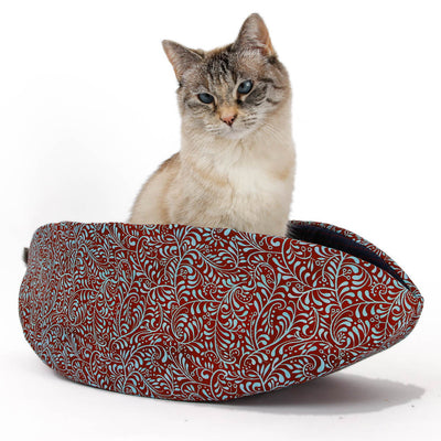 Our innovative Cat Canoe is made with a turquoise blue and red floral print cotton, and lined with a yarn dyed weave in navy blue with red window plane plaid squares.