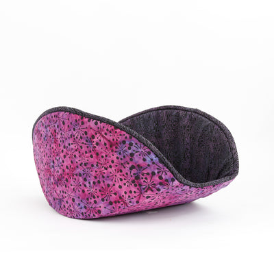 The jumbo size Cat Canoe® modern cat bed, made here in a lovely purple and pink cotton batik fabric, and lined with a black fabric with a maze design in purples and pinks. Our cat beds are made in the USA. 
