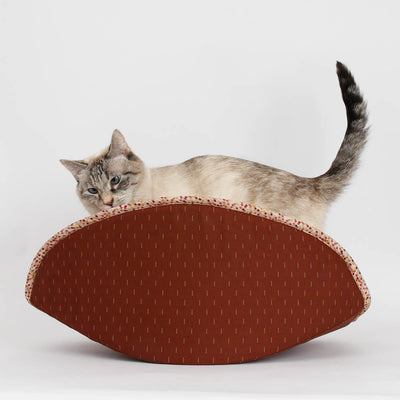 A small cat inside our jumbo-size CAT CANOE modern kitty bed. Designed for big kitties, this bed is made with brick red and terra cotta colored cotton over foam panels. Made in USA, ready to ship. 