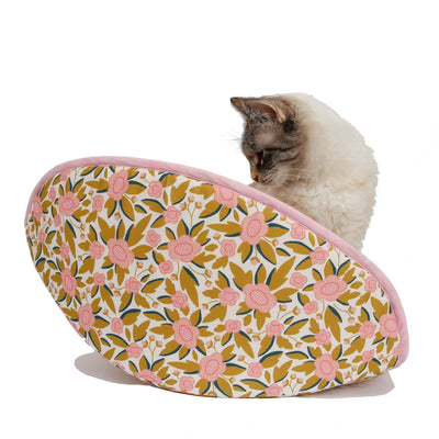 A small cat inside our new jumbo-size CAT CANOE. This bed was designed to accommodate multiple cats or cats over 18 pounds. Made here in a pink and white floral print.