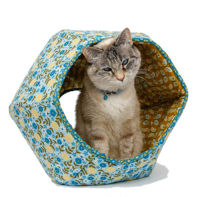 The Cat Ball® cat bed is a modern cat bed design, a cave-like pet bed with two openings. We've used a blue floral for this hexagonal pod-style pet bed and lined the flexible foam panels with a coordinating print of butterflies on a yellow background.